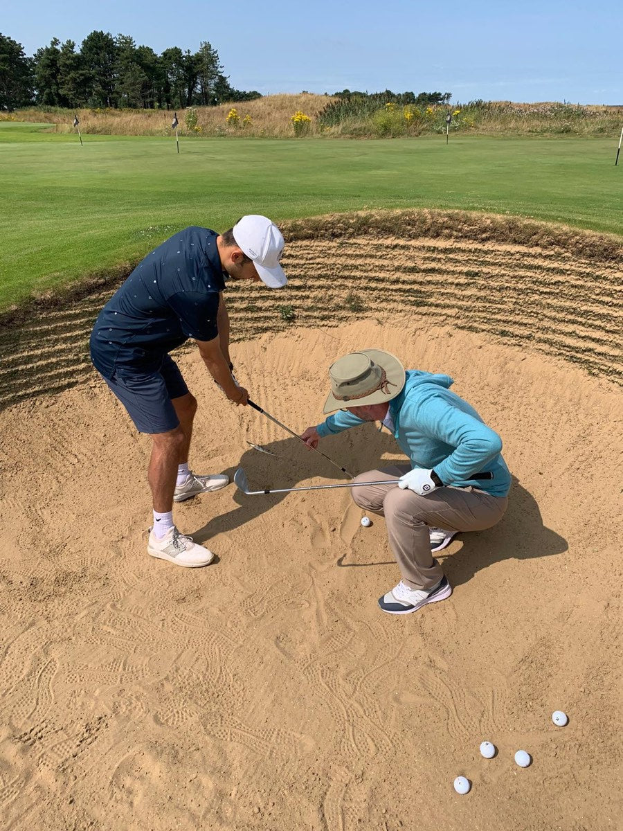 Matthew Wilkinson coaching a junior golfer